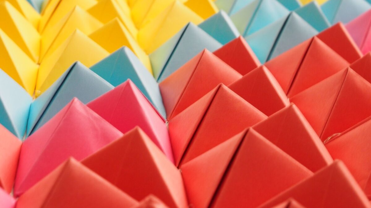 Vibrant folded paper pyramids in a colorful geometric pattern.