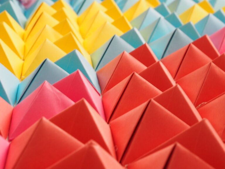 Vibrant folded paper pyramids in a colorful geometric pattern.